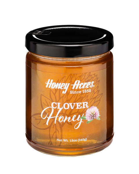 A jar of Clover Honey with the label 'Honey Acres - Clover Honey' and a floral design.