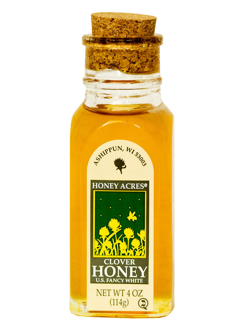 Bottle of Honey Acres Clover Honey with cork lid on a white background