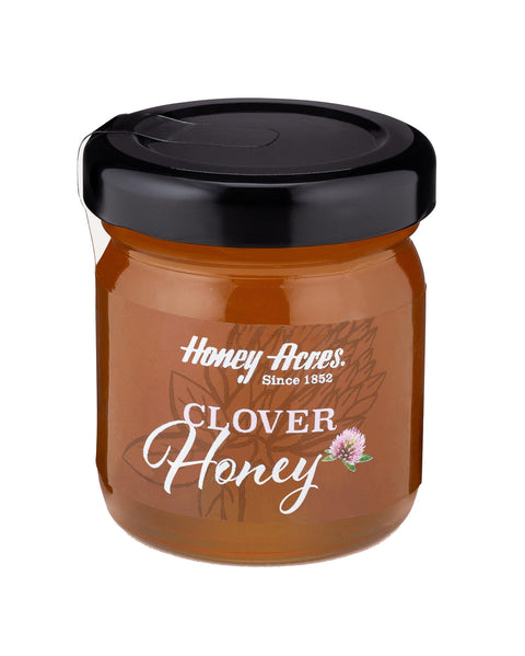 A jar of Clover Honey with the label 'Honey Acres - Clover Honey' and a floral design.