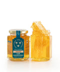 Two jars of honeycomb with a jar labeled 'Honeycomb' on a white background