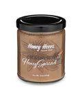 Jar of Honey Acres honey spread with a black lid on a white background