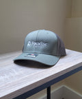 Gray cap with 'Foxadise Farms' logo on a wooden surface