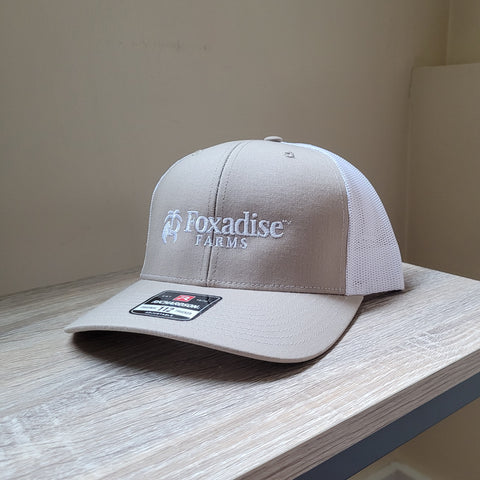Gray cap with 'Foxadise Farms' logo on a wooden surface