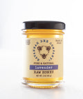 Jar of lavender raw honey from the Savannah Bee Company on a white background