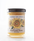 Jar of Savannah Bee Company sunflower honey with a sunflower design on the label.