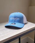 Blue cap with 'Foxadise Farms' logo on a wooden surface