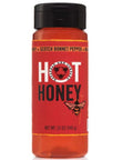 Red bottle of hot honey with black cap on a white background