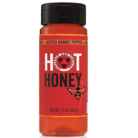 Red bottle of hot honey with black cap on a white background