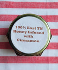 Honey container lid with text on a red and white striped background