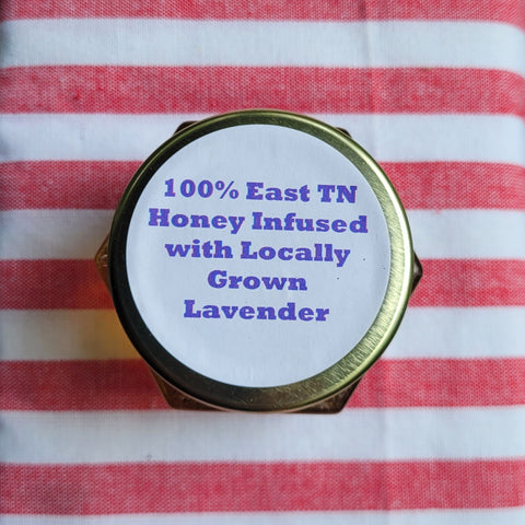 Honey jar lid with lavender text on a red and white striped fabric background