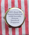 Honey jar with text on a red and white striped fabric background