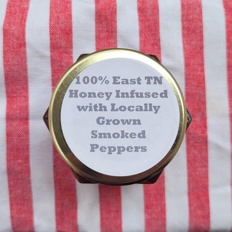 Honey jar with text on a red and white striped fabric background