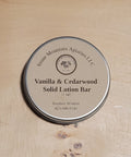 Vanilla & Cedarwood Solid Lotion Bar by Stone Mountain Apiaries LLC on a wooden surface