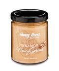 A jar of Clover Honey with the label 'Honey Acres - Cinnamon Honey Spread' and a floral design.