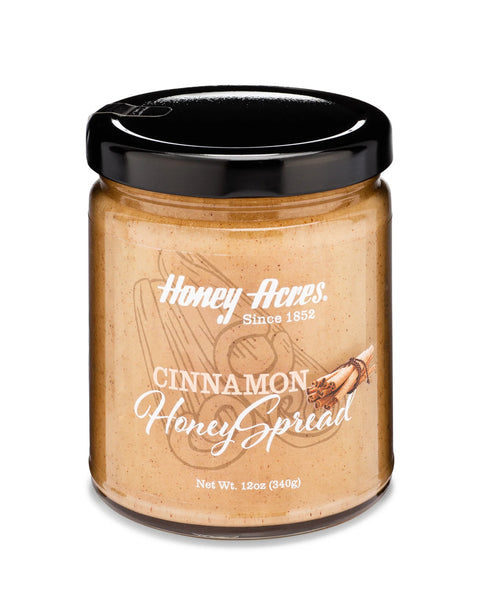 A jar of Clover Honey with the label 'Honey Acres - Cinnamon Honey Spread' and a floral design.
