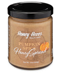 A jar of Clover Honey with the label 'Honey Acres - Pumpkin Spice Honey Spread' and a floral design.