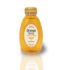 A jar of pure orange blossom honey from The Dutch Kettle, with a label indicating the product name and the weight of 16 oz.