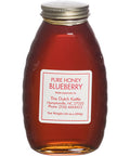 A clear glass jar filled with blueberry honey, with a label that reads 'PURE HONEY BLUEBERRY' along with the brand name and contact information.