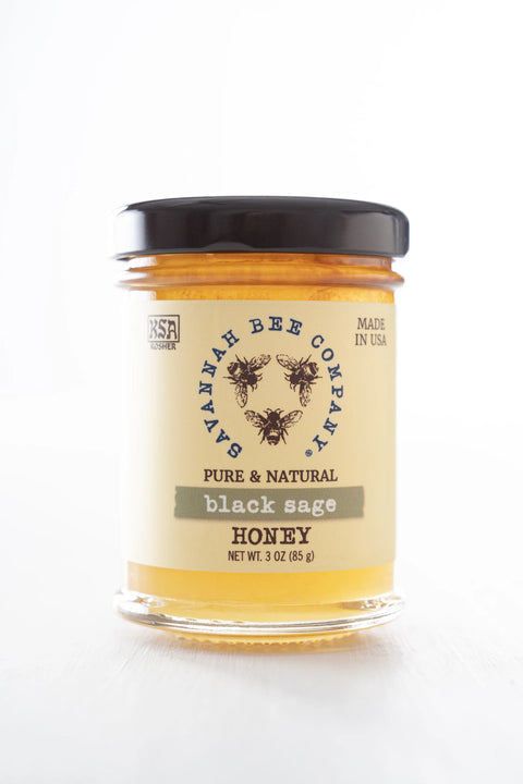 A jar of Black Sage Honey with a label indicating it is pure & natural, made in USA.