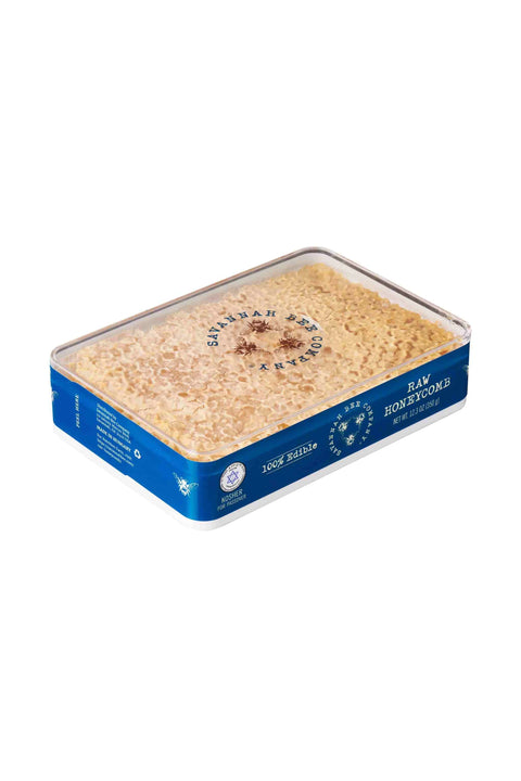 Box of raw honeycomb on a white background