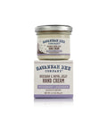 A jar of Savannah Bee Company's Rosemary Lavender Beeswax Handcream with a white label featuring those words and an image of bees.