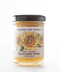 A jar of Savannah Bee Company Sunflower Honey with a label featuring a sunflower design.